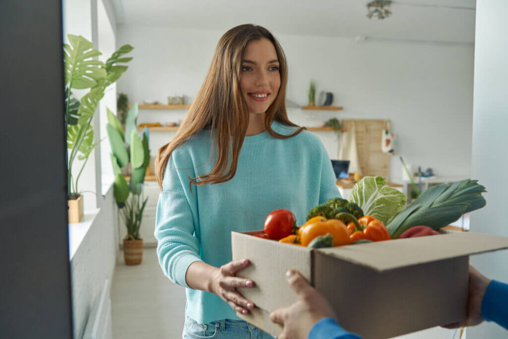 Customer receiving a box of fresh groceries